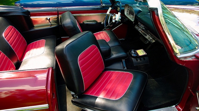 Old car with cool red seats but without seatblets